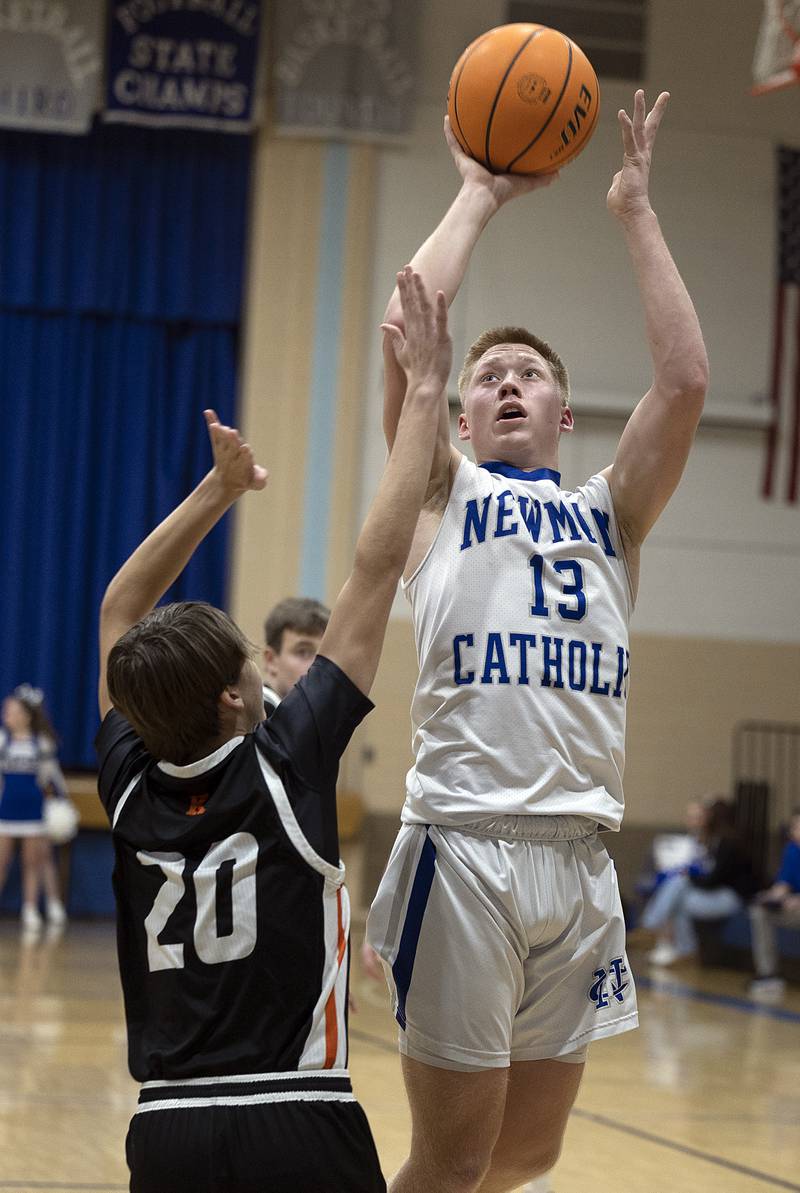Newman’s George Jungerman puts up a shot against Kewanee’s Griffin Hicks Friday, Jan. 10, 2025.