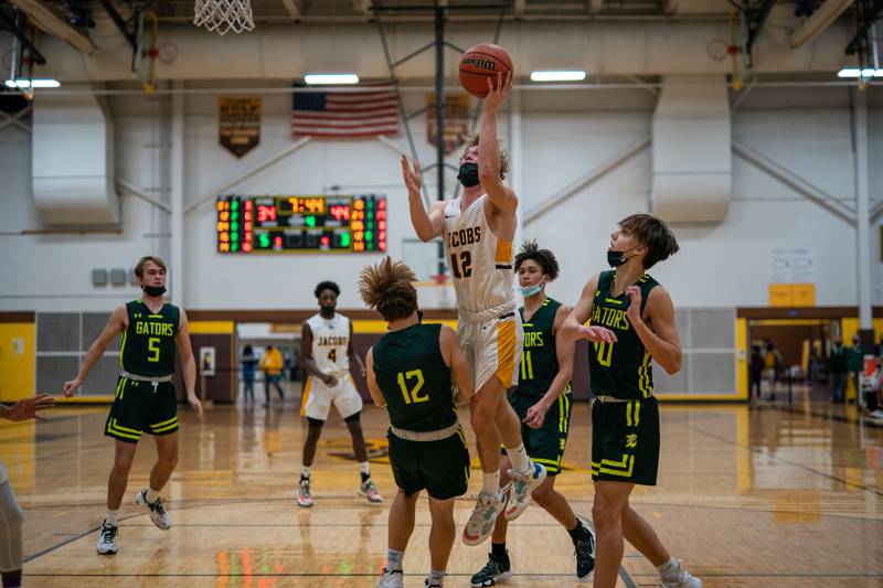 Jacobs’ Jackson Martucci drives to the basket against Crystal Lake South's Nathan Van Witzenburg during a basketball game at Jacobs High School in Algonquin on Friday, Dec 10, 2021.