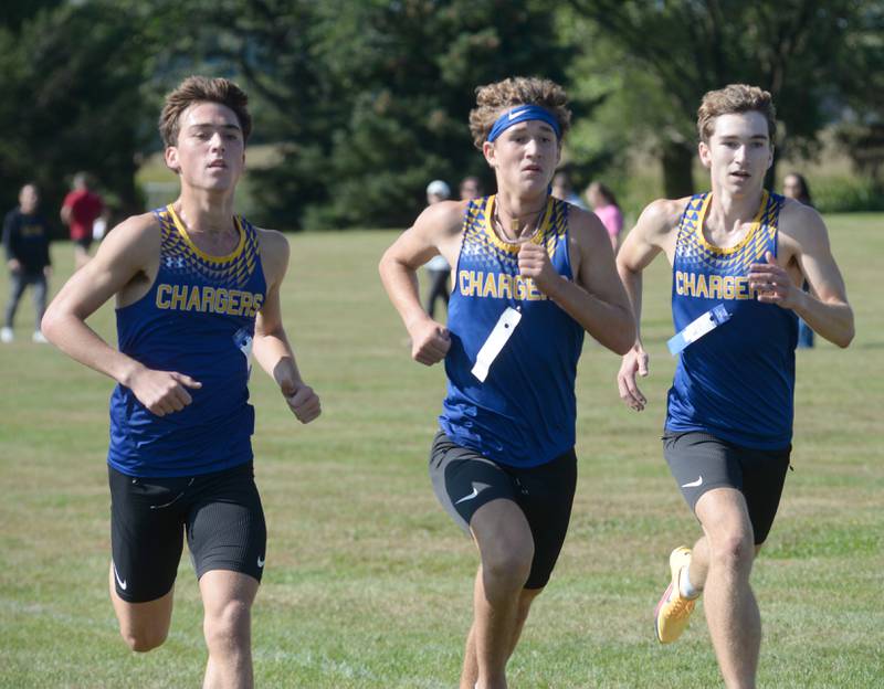 Aurora Central Catholic's Ben Bohr, Jack Swiatek, and John Reinbold race to the finish line at the Oregon Cross Country Open on Saturday, Sept. 6, 2025. Bohr  finished first,  Swiatek second and Reinbold third in the event, held at Oregon Park West.