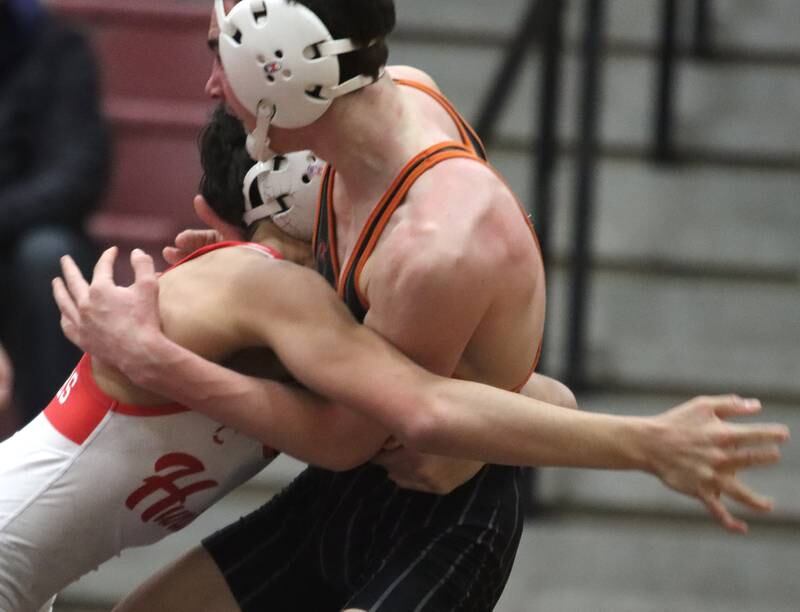Huntley’s Colin Abordo, left, charges against Crystal Lake Central’s Jackson Marlette at 116 pounds in varsity wrestling on Friday, Dec. 13, 2024 at Huntley High School in Huntley.