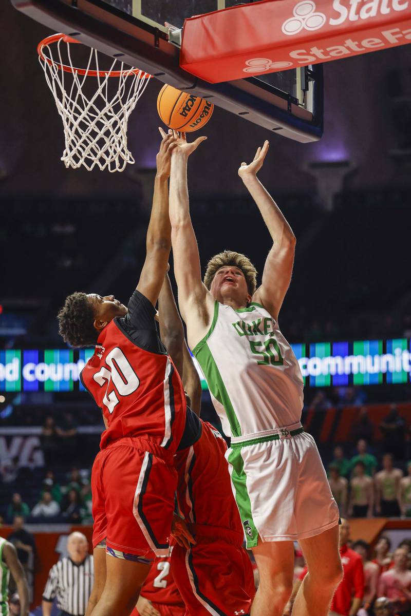 York’s Hunter Stepanich (50) goes hard to the basket over Marist's Kendall Meyers (20) during the IHSA Class 4A boys basketball state semifinal Friday, March 13, 2026 at the State Farm Center in Champaign.