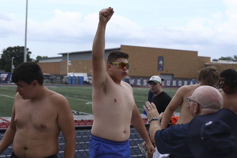 Burlington Central's Henry Crumlett celebrates after finishing first in his Watermelon Eating Race heat during the West Aurora "Battle of the Butts" Lineman Challenge, July 10, 2025  in Aurora.