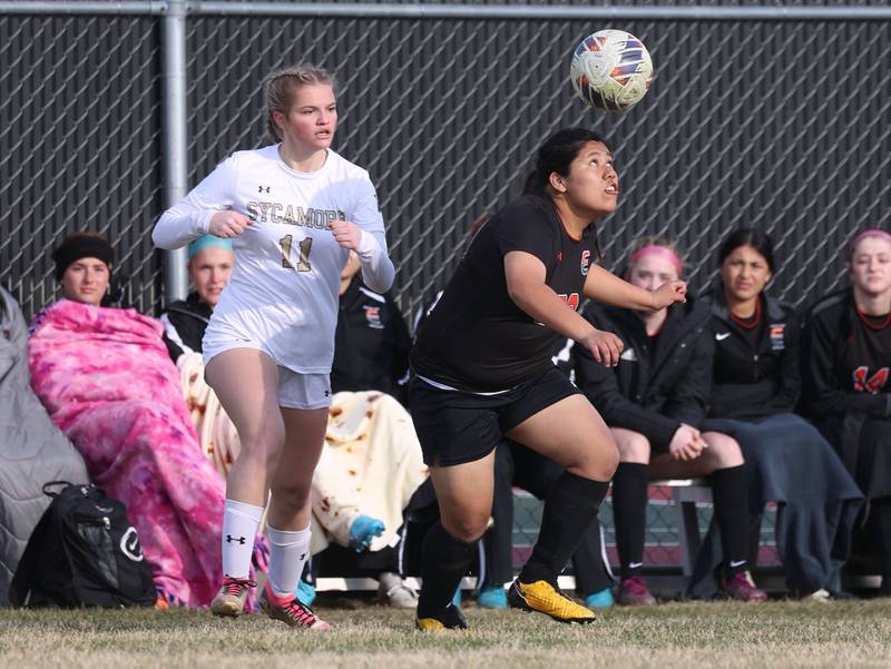 Plainfield East's Melanie Cuahuizo-Reyes heads the ball in front of a Sycamore player during their game Tuesday, March 25, 2025, in the Barb Fest tournament at DeKalb High School.