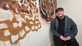 Joliet West journalism student freehands tiger mural