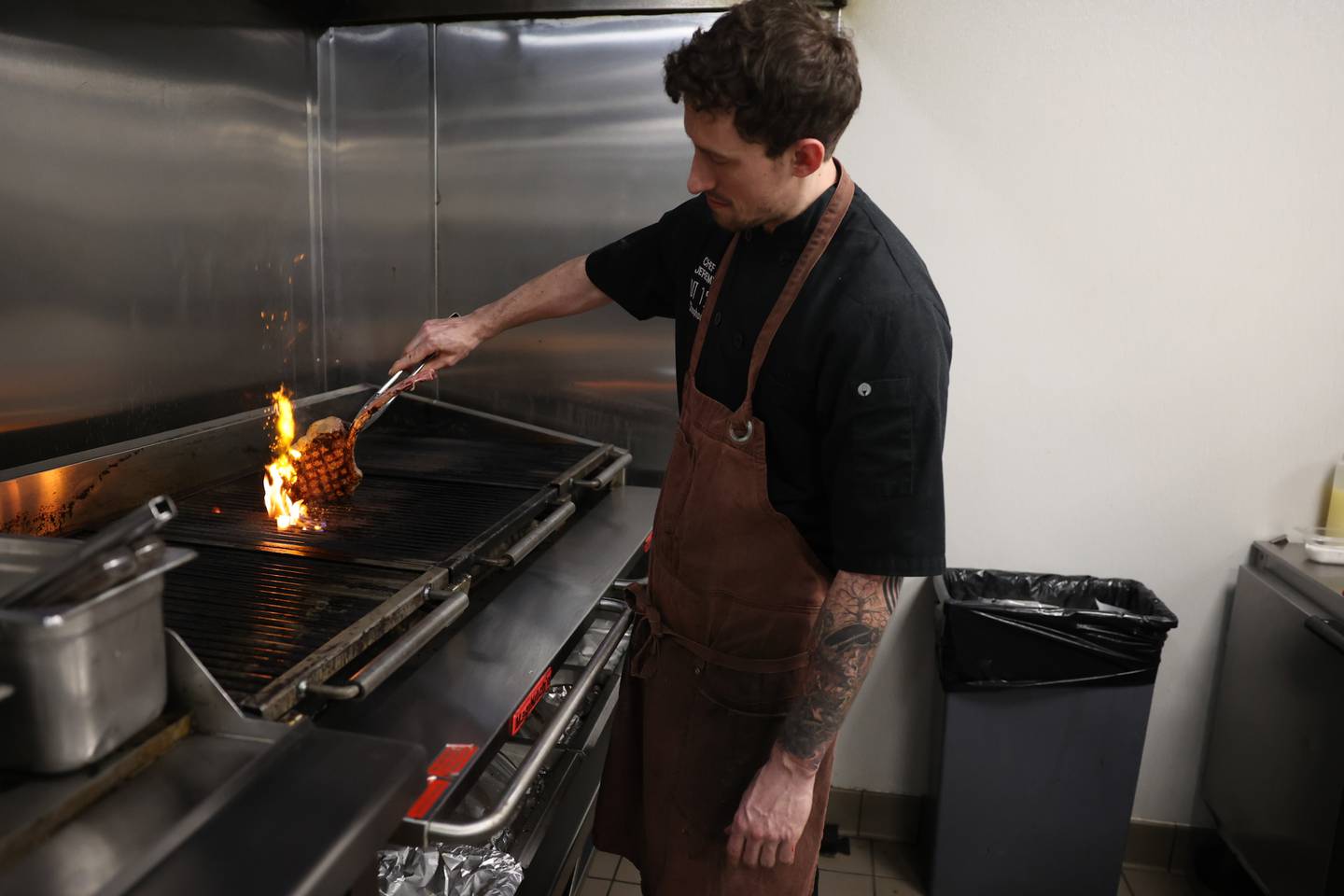 Executive Chef Jeremy Kenyon cooks a tomahawk ribeye at Cut 158 Chophouse.