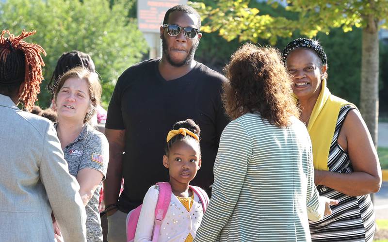 DeKalb School District 428 Superintendent Minerva Garcia-Sanchez (second from right) welcomes students and their families Thursday, Aug. 18, 2022, on the first day of school at Tyler Elementary in DeKalb.
