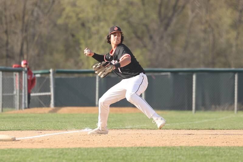 Lincoln-Way West’s Anthony Massa makes a throw to first for the out against Lincoln-Way East on Monday, April 24, 2023 in Frankfort.