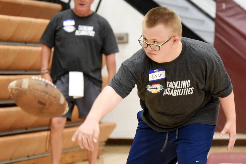 Evan Hudson spikes the ball after completing a drill at Watseka's Tackling Disabilities football camp Saturday, July 26, 2025.