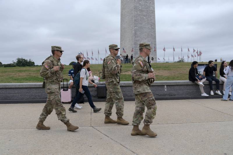 Members of the District of Columbia National Guard patrol near the Washington Monument on the National Mall, Tuesday, Aug. 19, 2025, in Washington. (AP Photo/Jose Luis Magana)