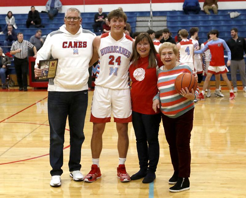 Marian Central’s Christian Bentancur with his father, Patrick, mother, Elizabeth, and his grandmother, Donna Dziuba, after he scored his 2,000 point during a nononference boys basketball game against Marengo on Tuesday, Feb.13, 2024, at Marian Central High School.