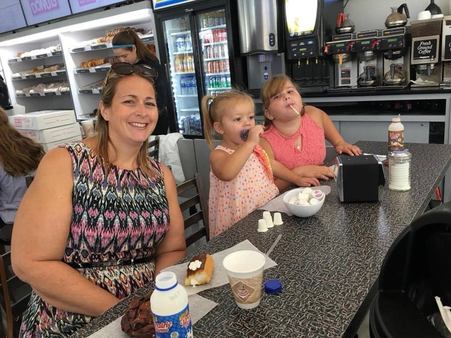 Mary Kay Bessler of Joliet (left) is seen treating her daughters Maggie Bessler (now 6) and Michaela Bessler (now 11) to doughnuts and more at Home Cut Donuts in Joliet.