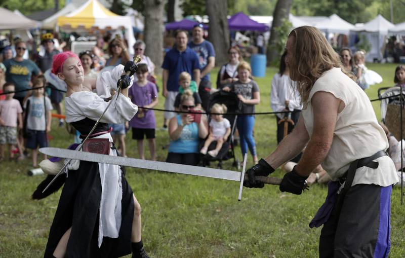 The Swords of Valour sword-fighting group members Krystiana Bernstein "Lillith" and Mark Weinberg "Boo Boo" both of Kalamazoo, Michigan battle during  the World of Faeries Festival Saturday August 6, 2022 at Vasa Park in South Elgin.