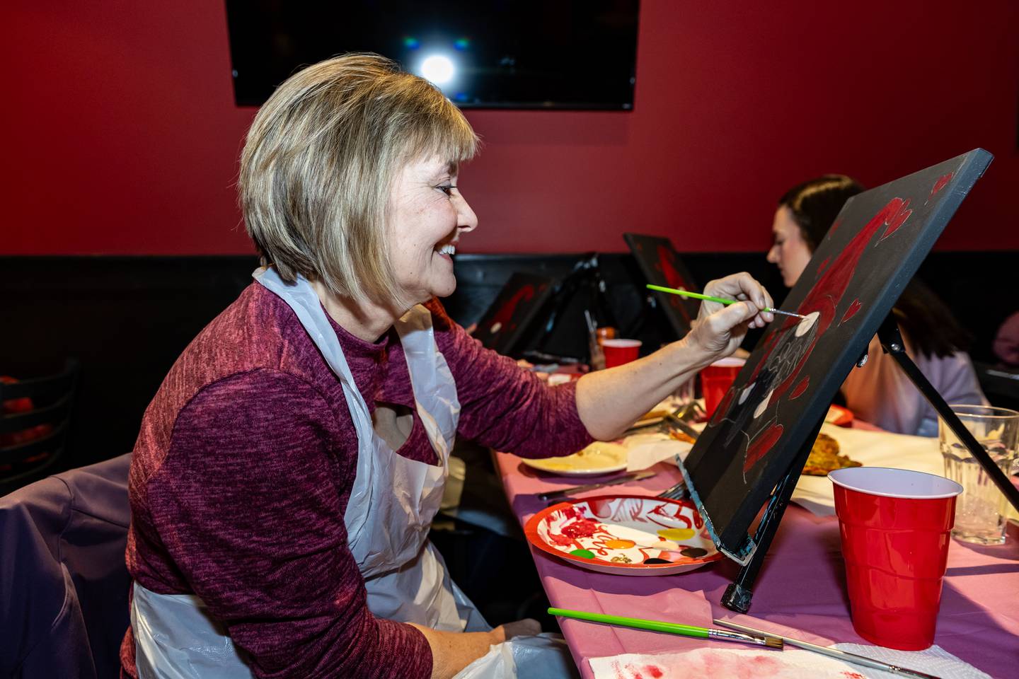 Lockport resident Sandy Tableriou works on a “Be My Valentine Gnome” during Divine Design Paint Studio's paint party at Papa Joe's in Lockport on Feb. 6, 2025.