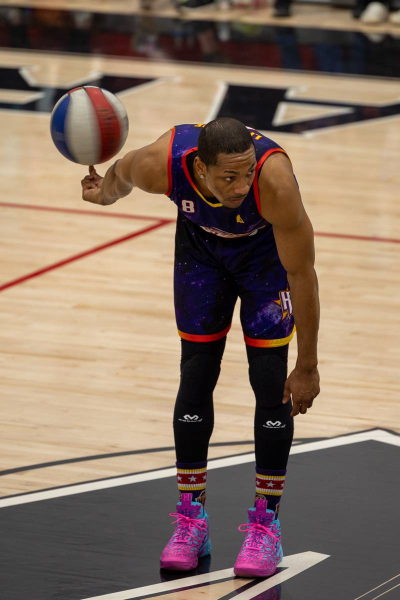 Devon “Livewire Curry (8) of the Harlem Wizards spins ball on finger behind his back on Wednesday, April 16, 2025 at Woodland High School in Streator.