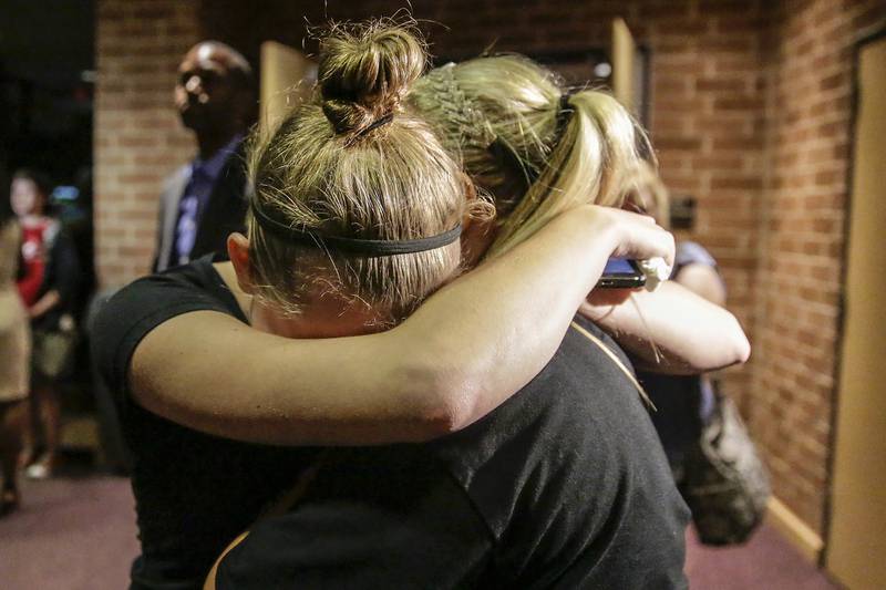 Lincoln-Way North seniors Shannon Orowick, 17, and Emma Curtin, 17, hug Thursday, Aug. 13, 2015, after the Lincoln-Way Community High School District 210 school board decided to close Lincoln-Way North.