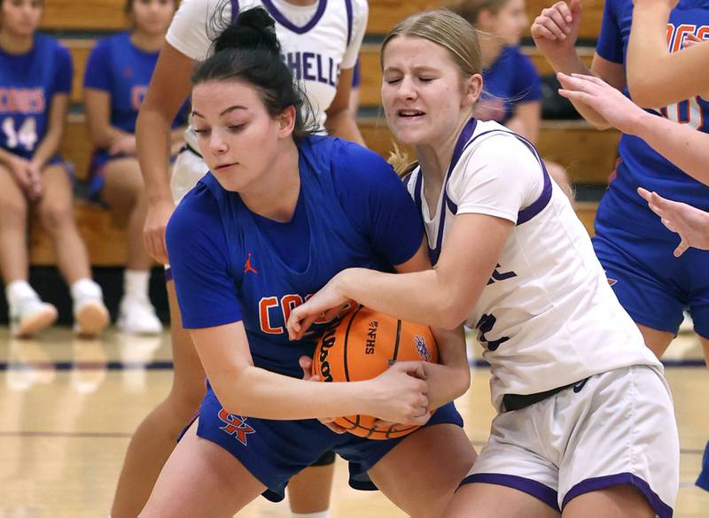 Genoa-Kingston's Zoe Boylen (left) and Rochelle's Natalie Foster fight for the ball during their game Monday, Dec. 15, 2025, at Rochelle High School.