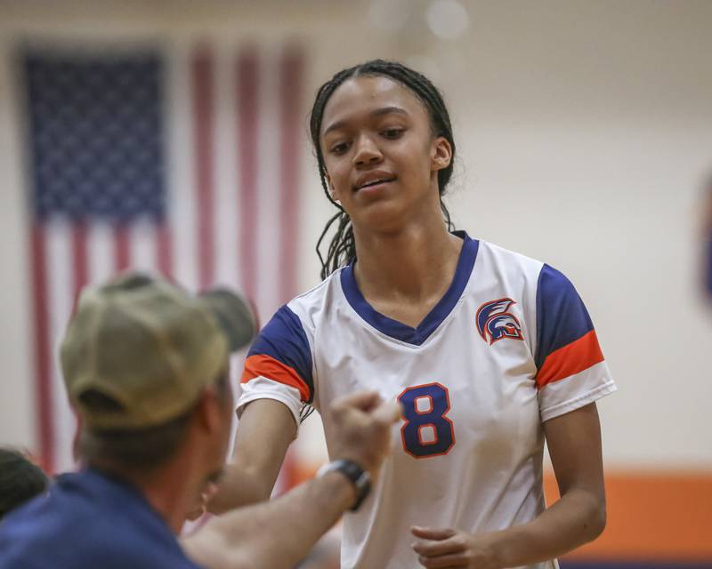 Romeoville's Arianna Thomas (8) is welcomed to the bench during volleyball match between Romeoville at Oswego. Oct 16, 2025.