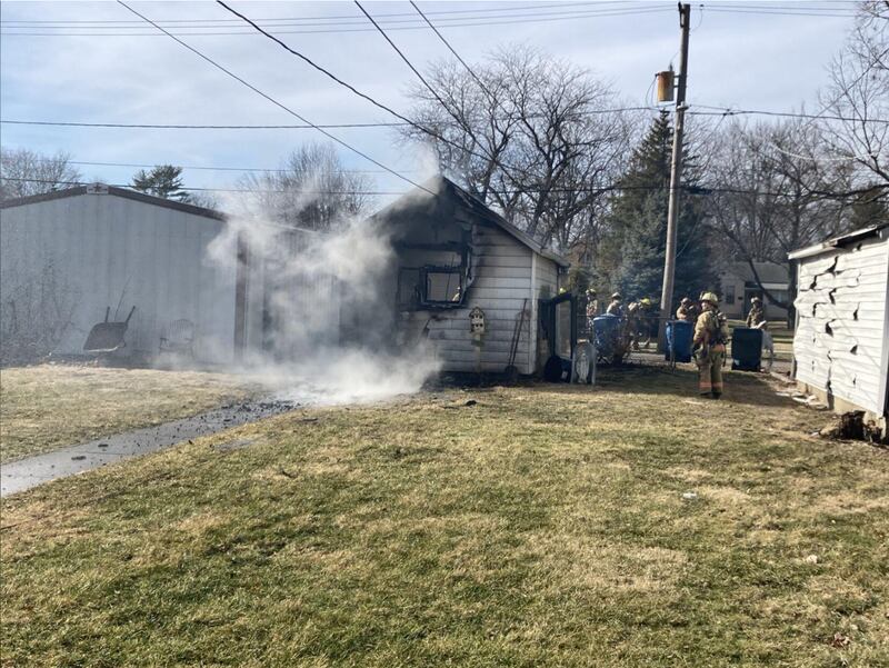 Firefighters from the Kankakee Fire Department finish extinguishing a fire that broke out in the detached garage of a house on Monday afternoon in the 1100 block of South Third Avenue in Kankakee.