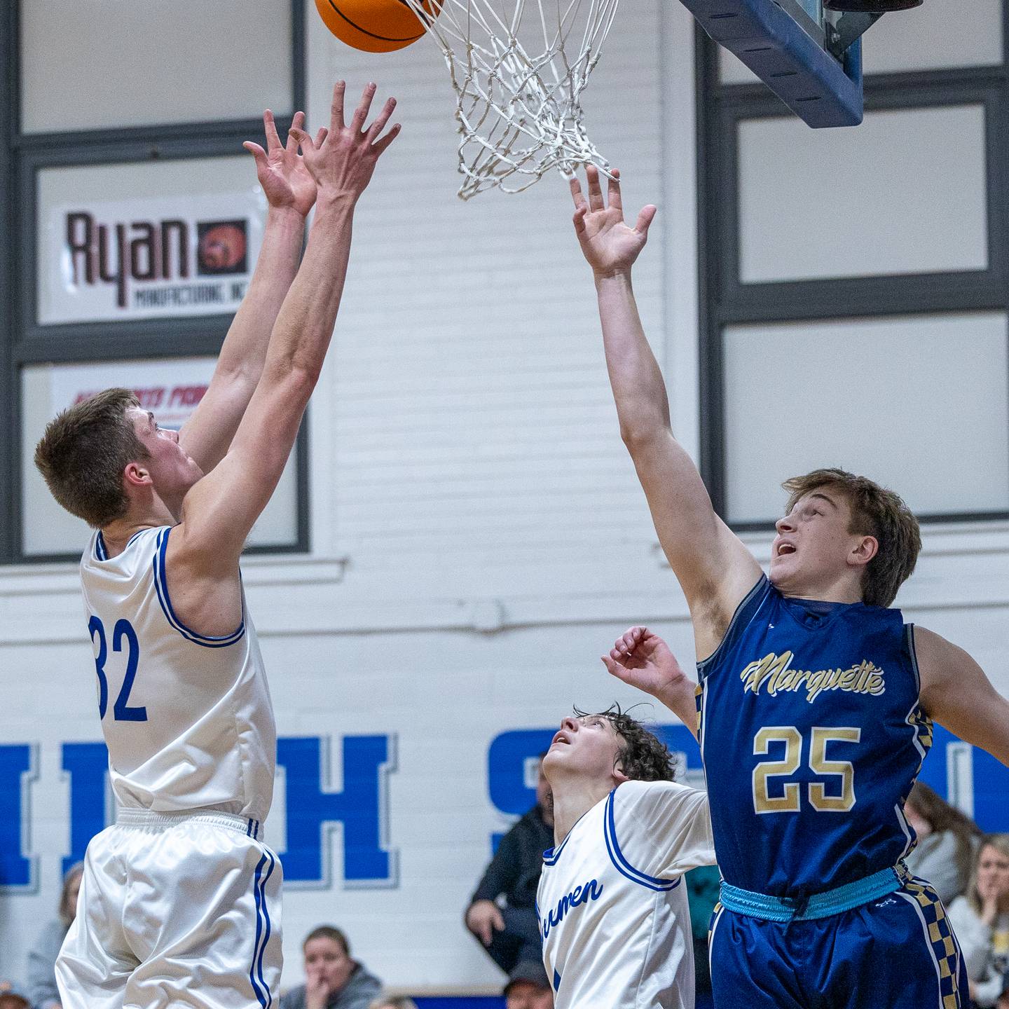 Clayton Christian (32) of Newark lays ball up in front of rim as Marquette's Caden Durdan (25) leaps in attempt to contest shot on Thursday, January 22, 2026 at Newark High School in Newark.