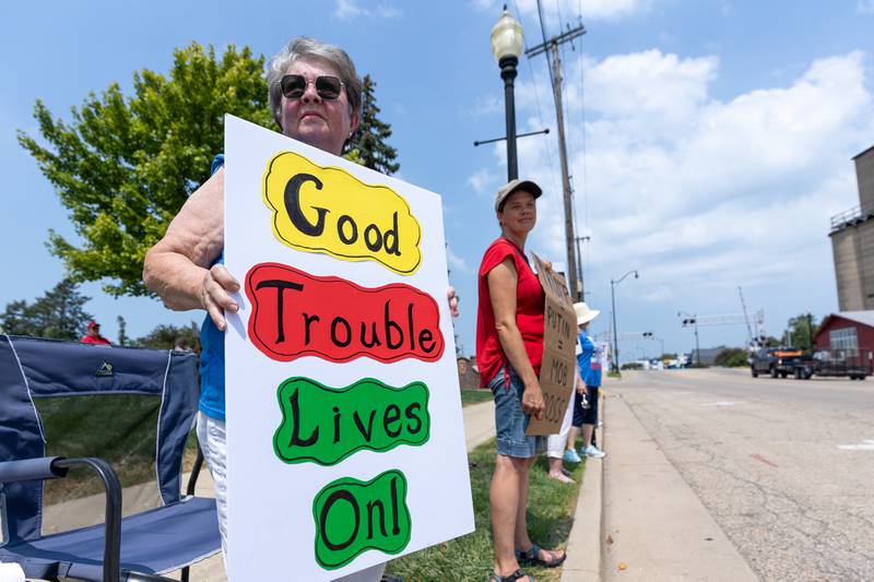 Protesters hold signs at the “No Kings” protest on Saturday,  August 9, 2025 at Rotary Park in Princeton.