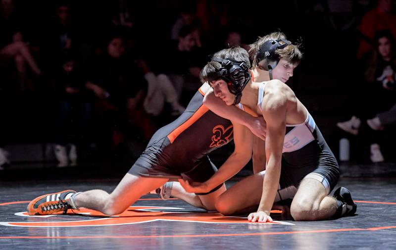 St. Charles East's Dom Munaretto and Marian Central's Chandler Gardner wrestle at 113 pounds during a match in St. Charles on Wednesday, December 20, 2023.