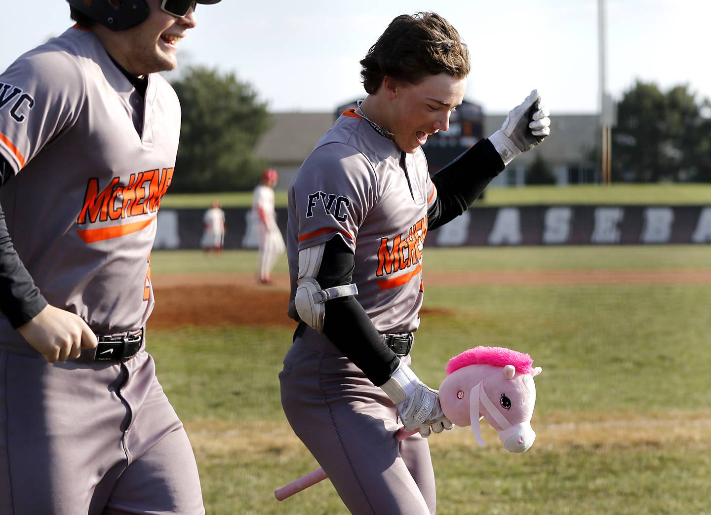 McHenry’s Carver Cohn celebrates his grand slam home run during a Fox Valley Conference baseball game against Huntley on Friday, April 11, 2025, at Huntley High School.