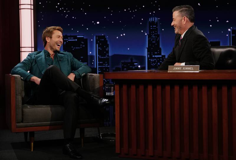 This image released by Disney shows guest Glen Powell, left, and host Jimmy Kimmel on "Jimmy Kimmel Live!" in Los Angeles on Tuesday, Sept. 23, 2025. (Randy Holmes/Disney via AP)