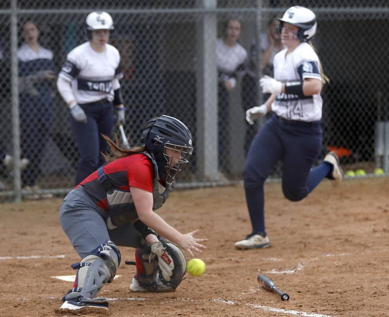 Dundee-Crown’s Faith Dierwechter tries to field the throw as Cary-Grove’s Allison Garski scores a run during a Fox Valley Conference softball game Monday, April 4, 2022, between Cary-Grove and Dundee-Crown at Cary-Grove High School.