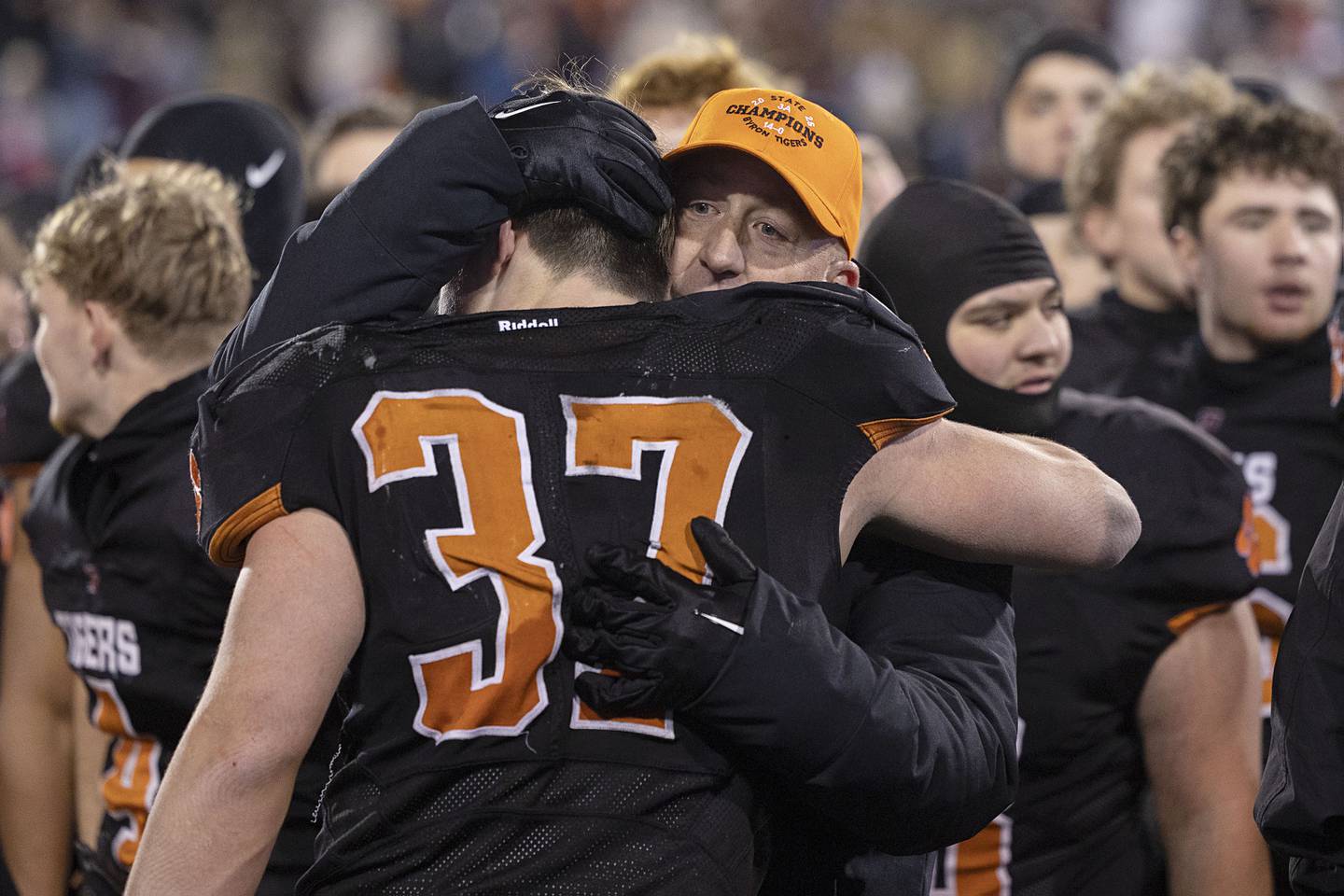 Byron head coach Jeff Boyer hugs Byron’s Caden Considine after the Tigers beat Tolono-Unity 56-50 Friday, Nov. 28, 2025, in the Class 3A football finals at Hancock Stadium at ISU.