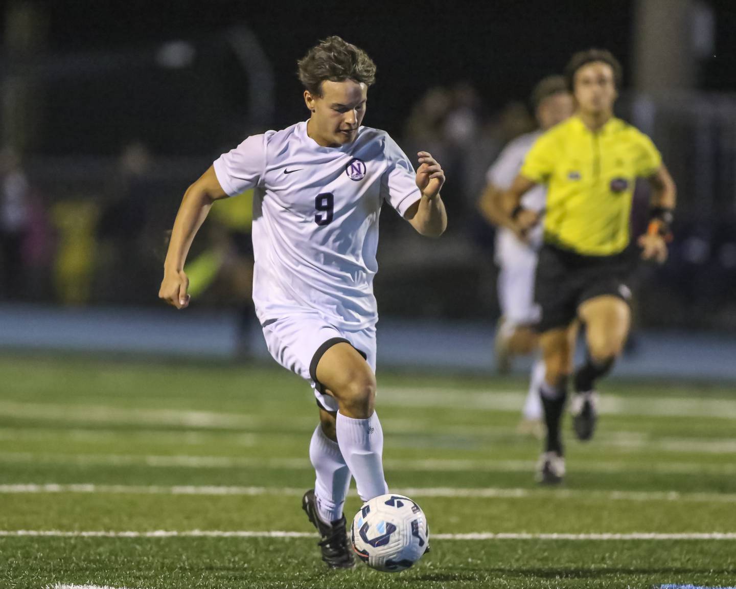 Downers Grove North's Ty Peboontom (9) races down the pitch during soccer match between Downers Grove North at Downers Grove South. Oct 2, 2025.