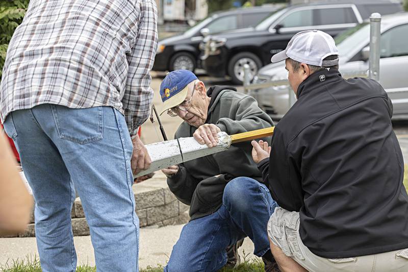 Lawrence Weinrich, Goodfellows board member, hacks at the steeple to remove the cross Wednesday, Sept. 13, 2023.