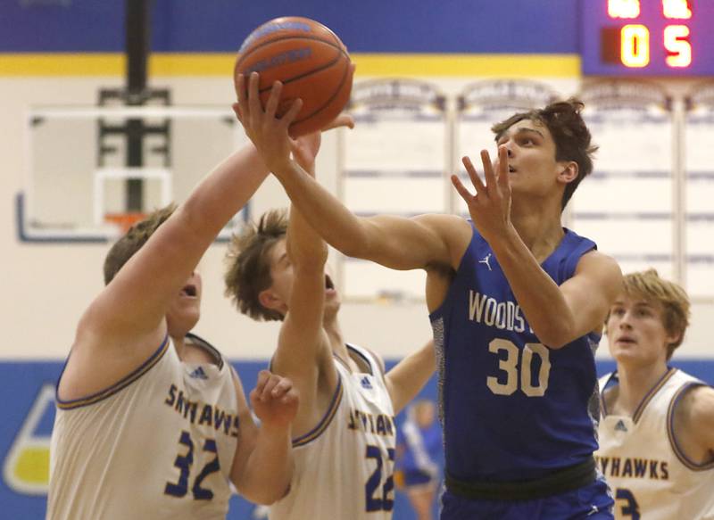 Woodstock’s Spencer Cullum drives to th abase tin front of Johnsburg's Jacob Welch, Gavin Groves, and Dylan Schmidt during a Kishwaukee River Conference boys basketball game Tuesday, Jan. 31, 2023, at Johnsburg High School.