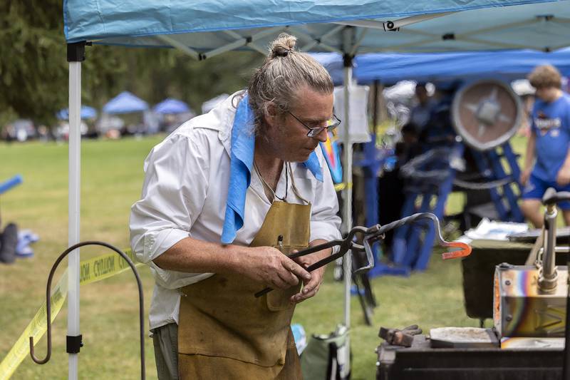 Blacksmith Trobey Trotter of Dixon works on a piece Saturday, Sept. 21, 2024, at Lowell Park’s Fall and Fantasy Fest.