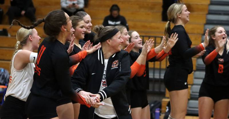 Crystal Lake Central’s Tigers, led by Head Coach Amy Johnson, center, celebrate after wrapping up a two-set win over Woodstock North in IHSA girls volleyball Class 3A Regional Championship action at Woodstock High School in Woodstock on Thursday, October 30, 2025.