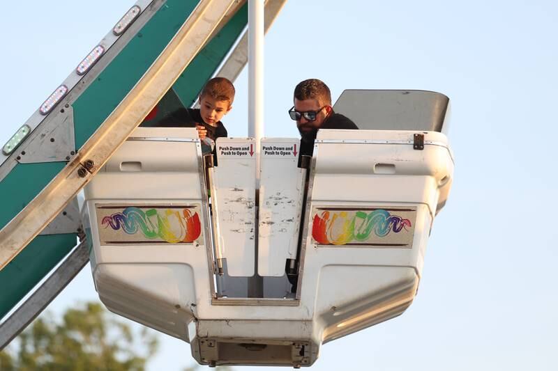 Cole and his father, Greg, look over the basket while riding the Ferris wheel at Lockport’s Canal Days on Friday, June 9, 2023.