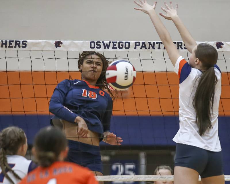 Oswego's Maya Norlin (18) goes for a kill during volleyball match between Romeoville at Oswego. Oct 16, 2025.