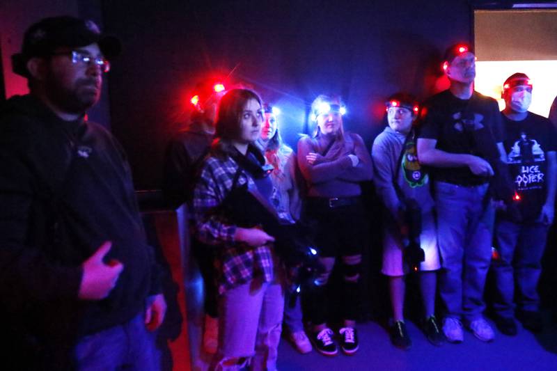 A group of customers listen inside the arena at Twisted Limits Laser Tag as the rules are explained Tuesday, Dec. 14, 2021, in McHenry.  The business opened last December.