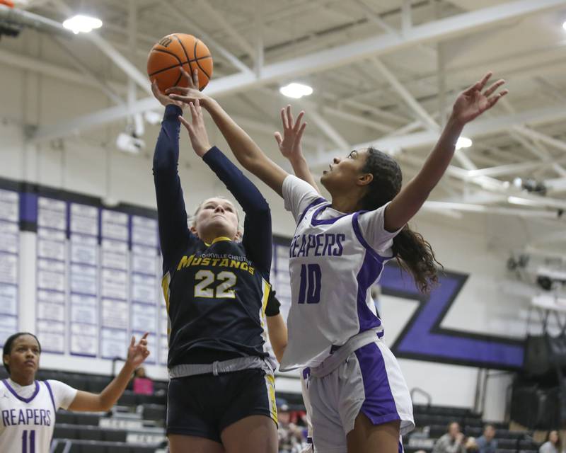Yorkville Christian' Avery Herron (22) puts up a shot while being defended by Plano's Jailyn Brown (10) during their basketball game between Yorkville Christian at Plano Wednesday, Jan 07, 2026 in Plano.