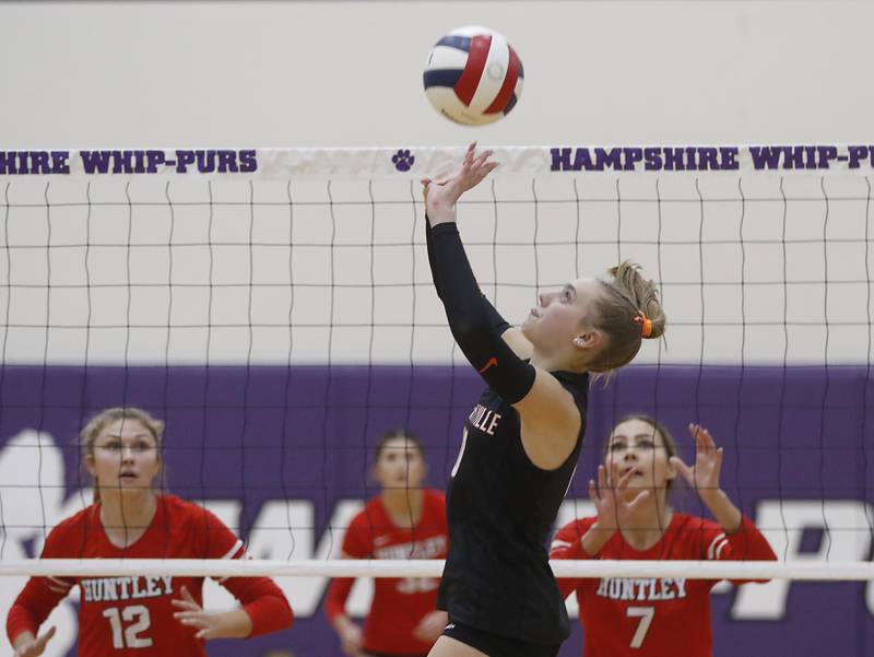 Libertyville's Avery Maddux (center) sets the ball in front of Huntley's Summer Massow (left) and Mia Jacobelli (right) during an IHSA Class 4A Hampshire Sectional semifinal volleyball match on Tuesday, Nov. 4, 2025, at Hampshire High School.