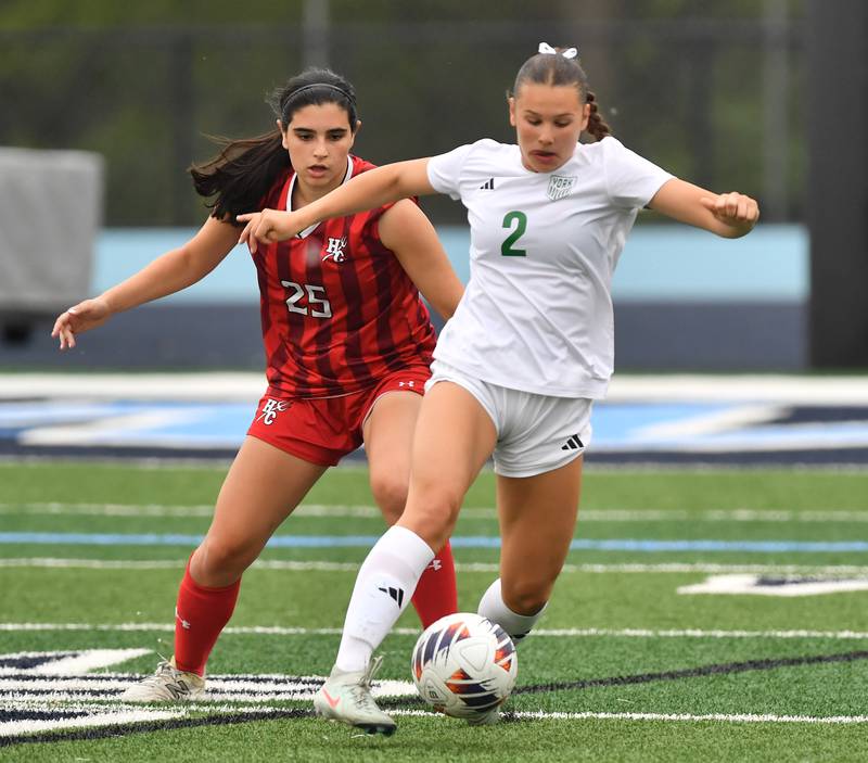 York’s Cate Carter (2) dribbles the ball as Hinsdale Central’s Adriana Giannini defends during the Class 3A Downers Grove South Sectional final game on May 30, 2025 at Downers Grove South High School in Downers Grove .