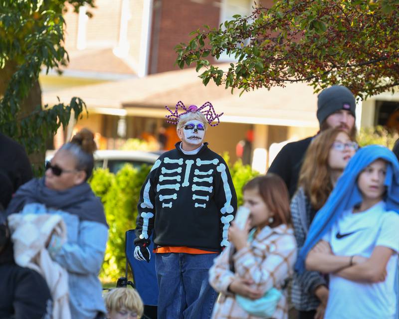 Sally Kirth of Evanston watches the Pumpkin Parade in downtown Sycamore on Sunday Oct. 27, 2024. Sally first attended the parade to watch her cousin perform in the junior high school band when she use to live in Darien. She said she's been coming to Sycamore Pumpkin Festival for more than 40 years.