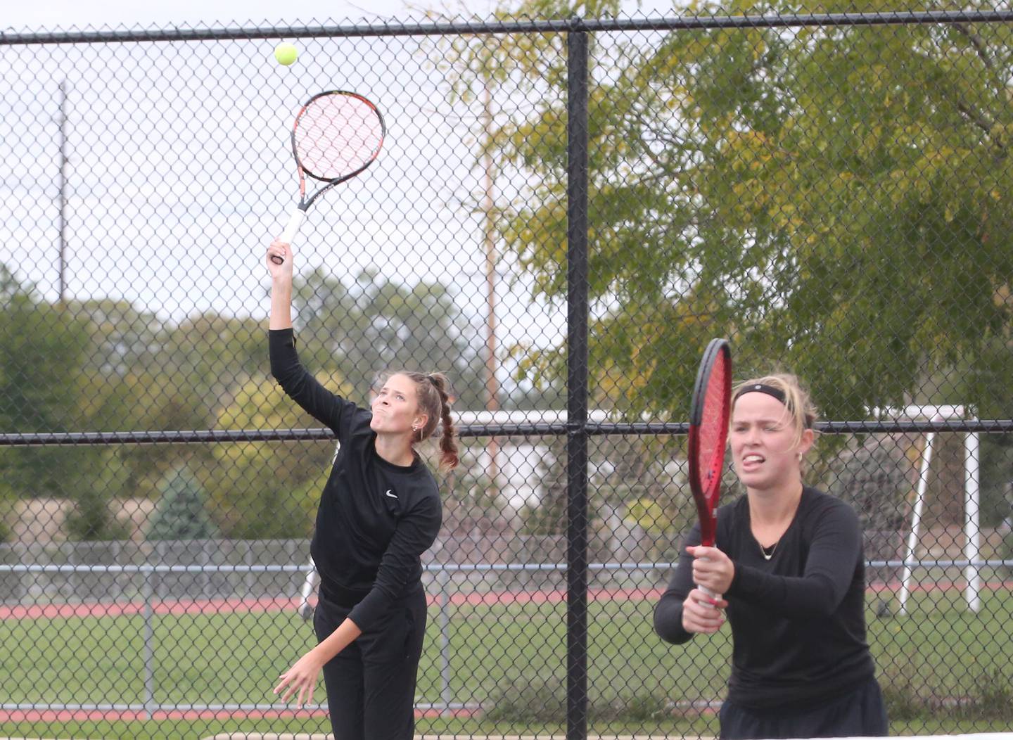 Ottawa doubles team of seniors Rylee O'Fallon (serving) and Emma Cushing play Morris doubles players Meghan Bzdill and Shreya Patel in the semifinals of the Class 1A Sectional tennis meet on Monday, Oct. 16, 2023 at the La Salle-Peru Sports Complex in La Salle.
