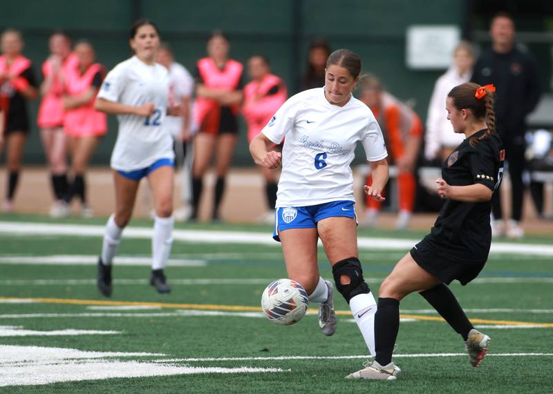 St. Charles North's Maddie Room chases the ball during a Class 3A Glenbard West Sectional semifinal game against St. Charles East on Tuesday, May 27, 2025 in Glen Ellyn.