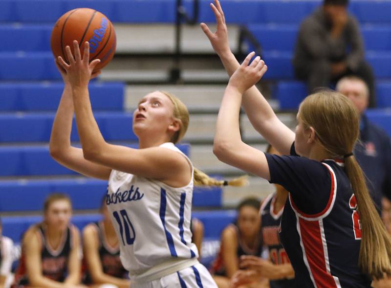 Burlington Central's Ashley Waslo drives to basket in front of Belvidere North’s Samantha Adams on Monday, Nov. 13, 2023, during pool play girls basketball game in the Burlington Central Mark Einwich Tournament.