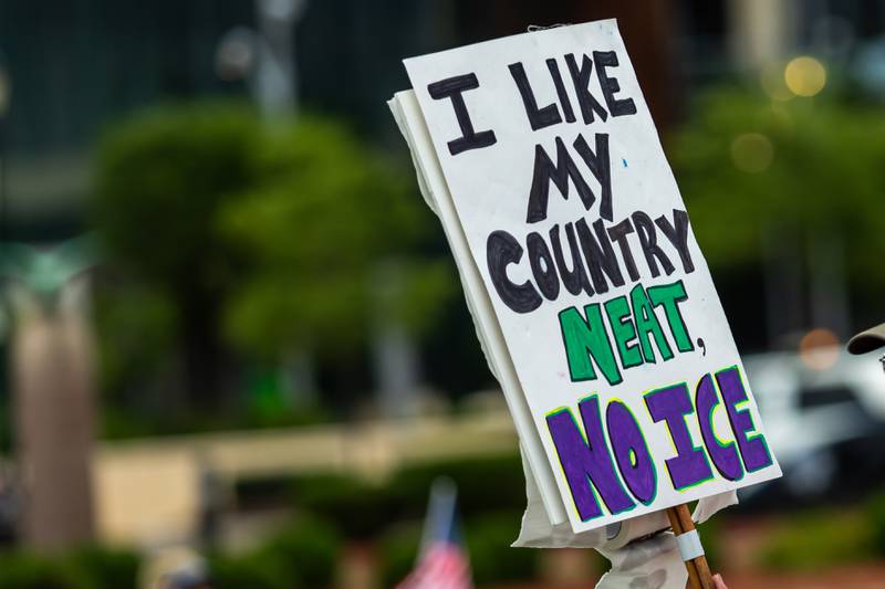 An attendee holds up a sign at the Good Trouble Lives On event in Downtown Joliet on July 17, 2025.