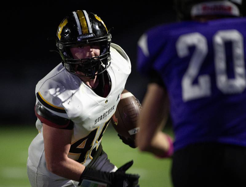 Herscher's Jaxon Sukley carries the ball after a reception while trying to get past Manteno's Briggs Cann in a game on Friday, September 12, 2025.