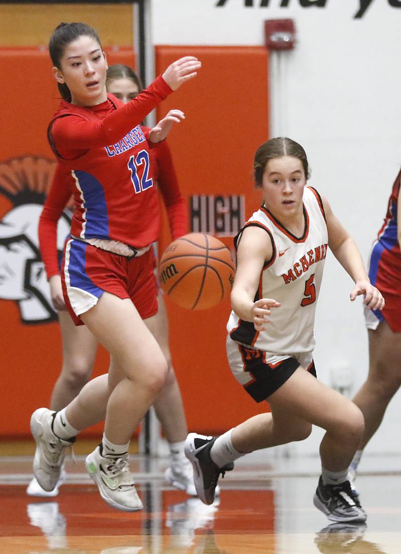 Dundee-Crown’s Charlotte Stewart and McHenry's Gaby Grasser chase after a loose ball during a Fox Valley Conference girls basketball game on Tuesday, Dec. 12, 2023, at McHenry High School.