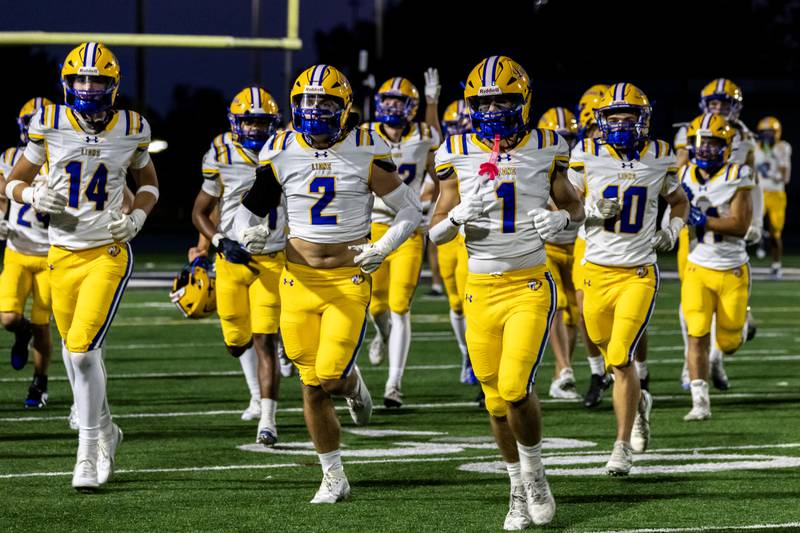 Lyons Township’s varsity football prepares for a varsity football game against Joliet Catholic at Busey Bank Field at Joliet Memorial Stadium on Aug. 29, 2025.
