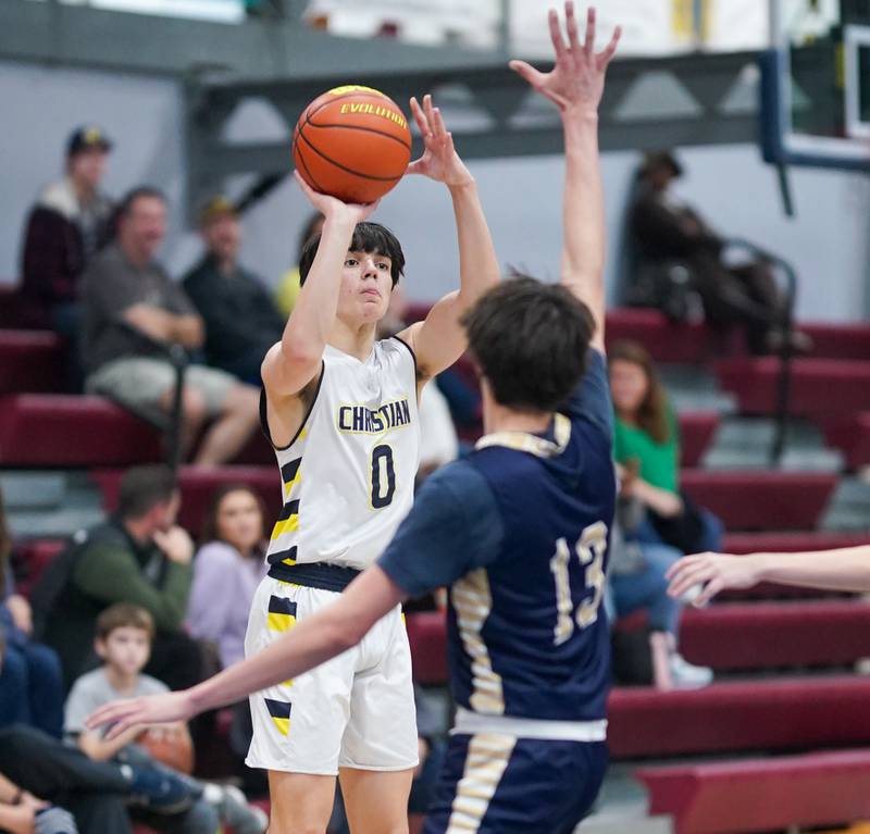 Yorkville Christian's Zach Marini (0) shoots a three pointer against Hiawatha's Cameron Emerich (13) during a basketball game at Yorkville Christian High School in Yorkville on Friday, Jan 5, 2024.
