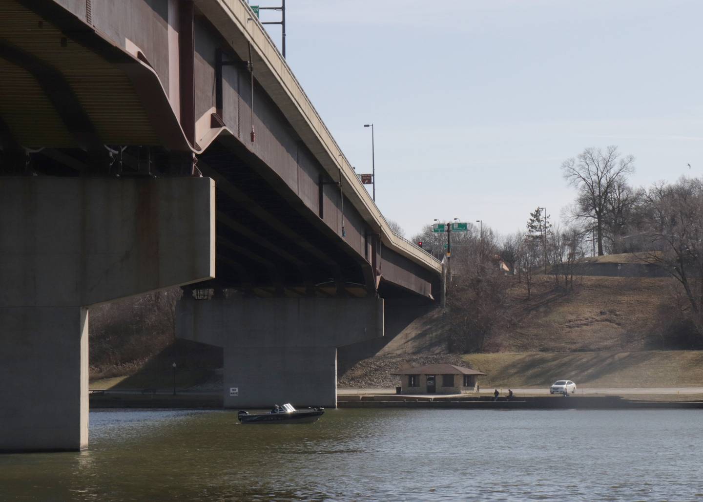 A boater cruises underneath the Veterans Memorial Bridge on Monday, Feb. 26, 2024 in Ottawa. Record high temperatures of 70 degree weather graced the Illinois Valley.